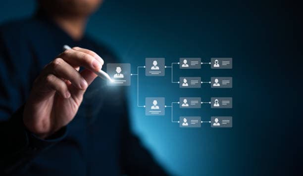 Hand with a stylus drawing a digital organization chart