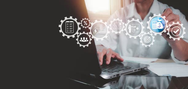 Person at a laptop with a row of connected process gears for finance, planning and targets