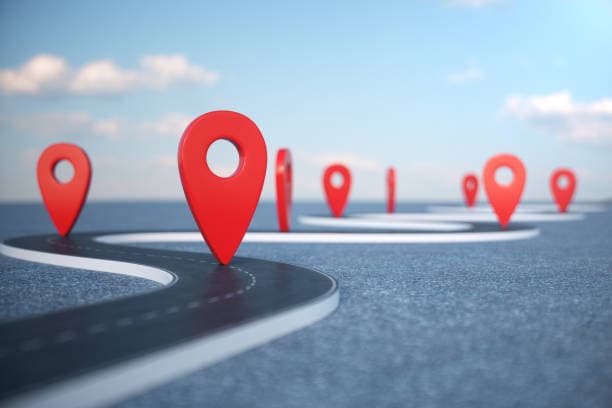 Winding road with red location pins marking stops along the way